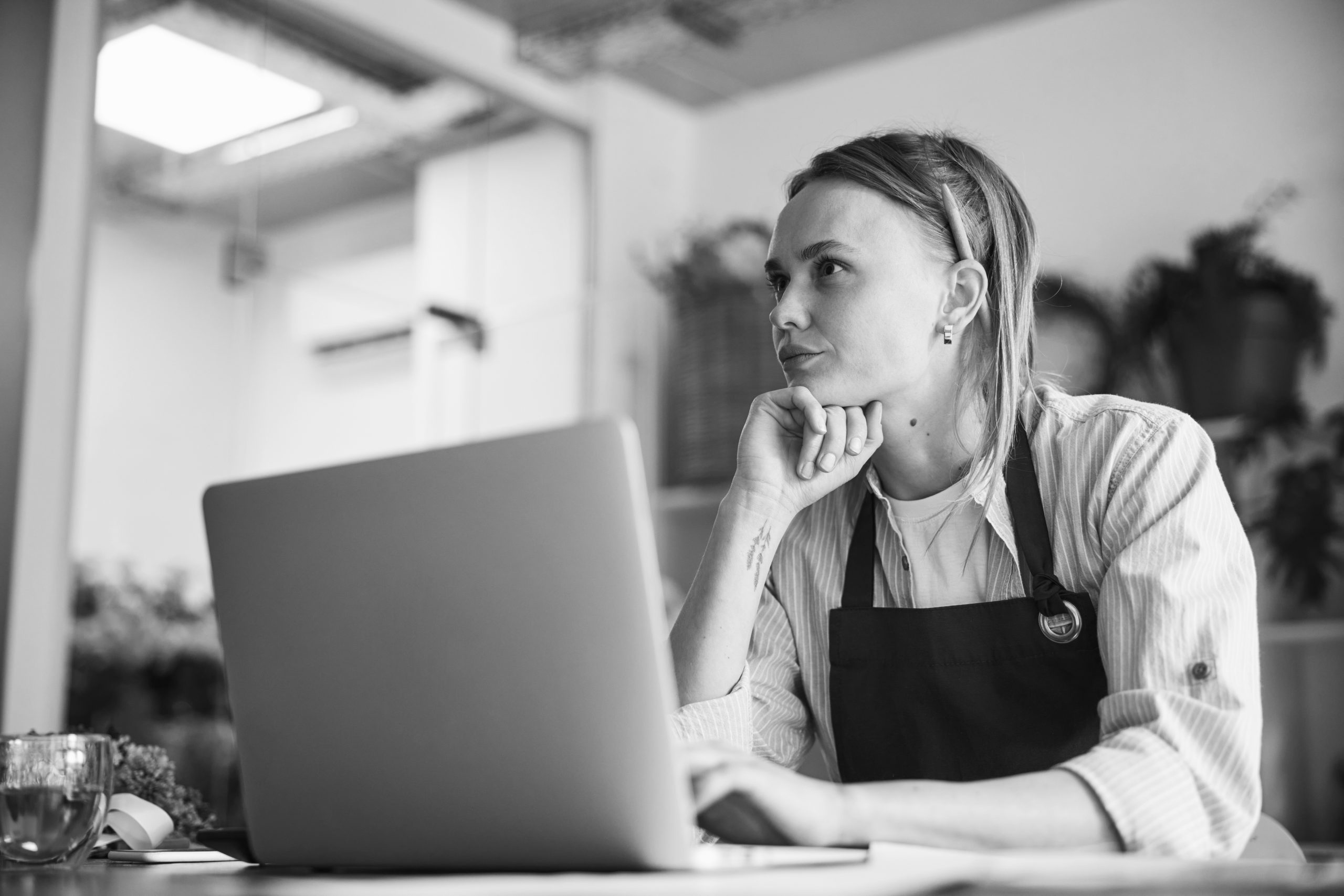 thoughtful floral designer seated at her laptop 2026 03 10 03 58 17 utc scaled